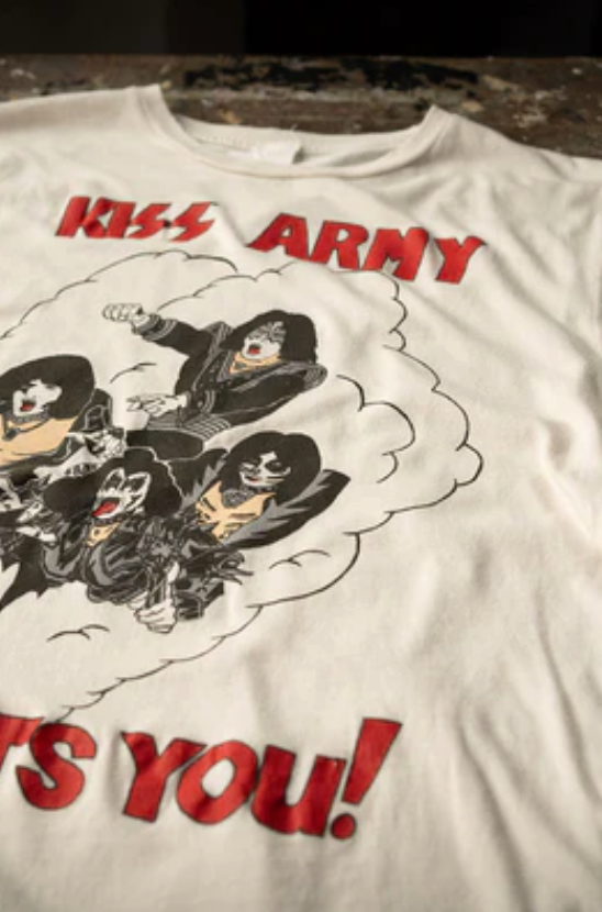White t-shirt featuring a graphic of the band KISS in their iconic makeup with the phrase "KISS ARMY WANTS YOU!" depicted in bold, Arizona red letters by Made Worn.