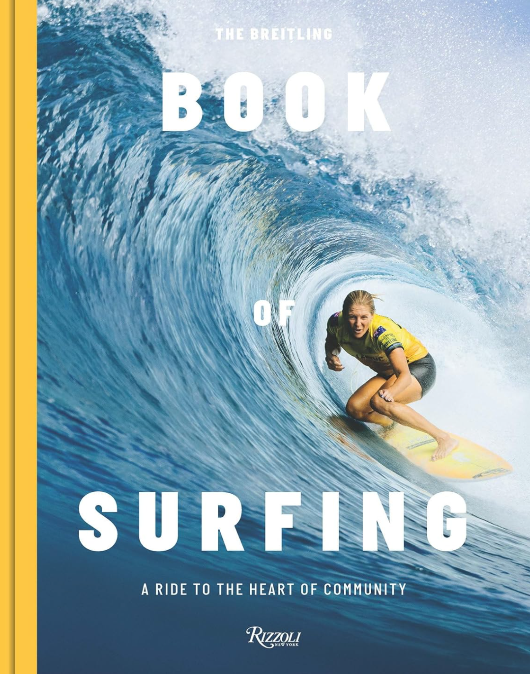 Cover of "The Breitling Book of Surfing: A Ride to the Heart of Community" by Random House. It showcases a surfer riding a wave, dressed in a yellow top, with the ocean and blue sky as the backdrop. The bold white text stands out against this vivid portrayal of contemporary surf culture.