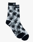 The Step Up Sock by Mother highlights a bold black and white star pattern, complete with a top band that features partially visible text on a dark background. Laid flat on a white surface, these socks combine style and comfort with every step.