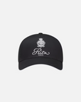 The FRAME Ritz Cotton Trucker is a classic black baseball cap crafted from 100% cotton, featuring the iconic Ritz Paris logo with an emblem above "Ritz Paris" in elegant white script on a clean white background.