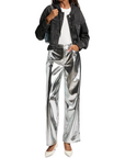 Someone in a Rag & Bone miramar terry hood trckr jckt, white top, shiny silver metallic wide-leg pants, and white pointed-toe heels stands against a white background.