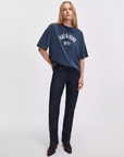 Rag & Bone university alex tee in white, styled with dark jeans against a plain background.