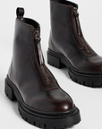 Dark brown leather ankle boots with chunky soles and front zippers by Staud, Miles Zip style.