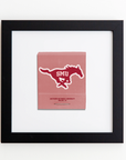 A framed print displays a pink paper bag with the Southern Methodist University (SMU) logo of a running mustang and "SMU" text on it. Below the logo, it reads "Southern Methodist University, Dallas, TX." The Match South Art Square Blk Frame features a white flat profile and is hung on a white wall.