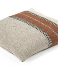 The Montana Pillow by Libeco Home is a square beige throw pillow featuring two wide rust stripes bordered by black herringbone zigzags—perfect for adding a cozy, rustic winter touch to your space.