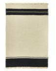 The Marshall Throw by Libeco Home is a rectangular beige linen-wool blend with flax fringe, fringed edges, and two black stripes near the top and bottom for a minimalist, timeless look.