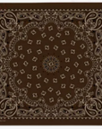 The Silk Bandana by The Great Inc. is a brown silk bandana with a classic paisley pattern in white and tan, featuring intricate floral and teardrop designs that create a symmetrical border and central motif.