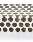 The Dot Chiseled Covered Box by Two's Company features a rectangular white design with large, evenly spaced black dots. Closed and stylish, it resembles handcrafted decorative boxes and sits elegantly on a white surface.