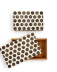 The photo shows two Dot Chiseled Covered Boxes by Two's Company with black polka dots on beige. One box is closed, and the other is open with its lid angled beside it, revealing a plain brown interior.