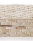 The Basketweave Bone Box by Two's Company features a rectangular, cream-colored design with a fitted lid, smooth uniform texture, and an elegant basket weave pattern.