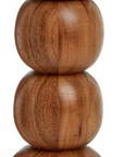 The Two's Company Pillar Candleholder is hand-crafted from acacia wood with four stacked, rounded segments that decrease in size. Its smooth finish adds to the mid-century modern style.