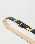 The Marc Belt by B-Low The Belt features black calfskin leather, gold-tone hardware with a matching gold loop, and a tan inner side, shown coiled on a white background.