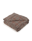 The Libeco Home Jude Check Duvet, featuring a plaid pattern in brown, gray, and red tones, is shown folded on a white background. Proper linen care keeps this duvet soft and its colors vibrant for lasting comfort.