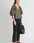 Apiece Apart Nele Lantern Sleeve Top styled with black jeans and loafers, casual modern look, side profile view.