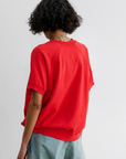 Red Rachel Comey Billi Sweatshirt styled with light blue jeans, model shown from behind, casual look.