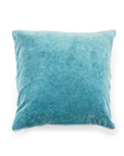 The Velvet Pillow W/ Poms by Sugarboo Designs is a square, blue velvet accent pillow featuring slightly uneven corners and subtle texture, shown against a plain white background.