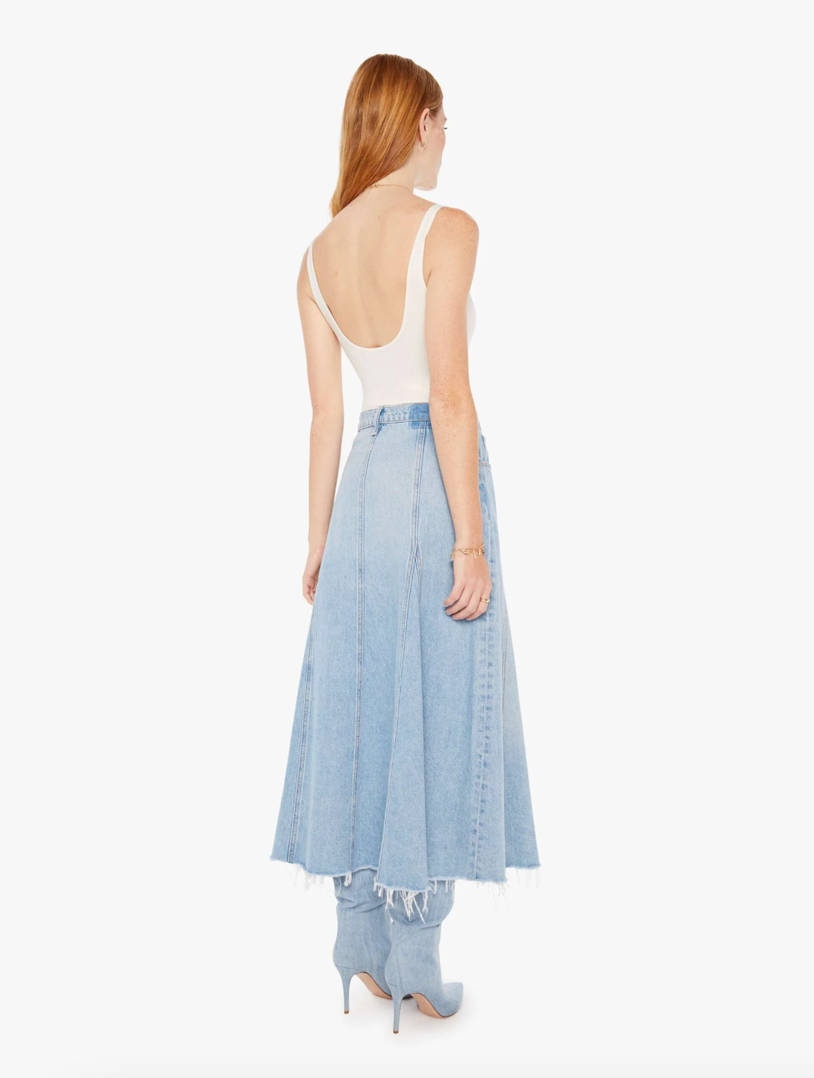 The woman is wearing The Full Swing I'm With The Band tank top with a long blue denim skirt with frayed edges, paired with blue high-heeled shoes styled for an Arizona look. She is standing on a plain white background.