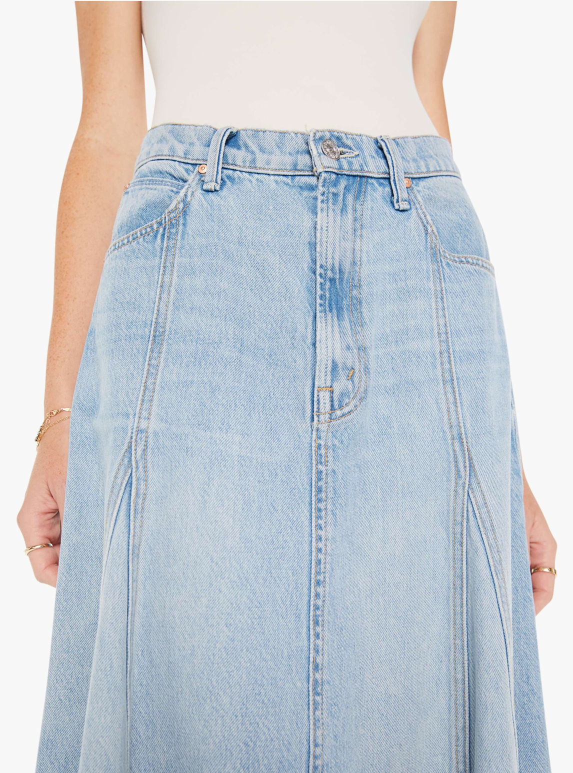 Close-up view of a woman wearing The Full Swing I'm With The Band denim skirt, showing details from waist to mid-thigh, with a focus on the skirt's stitching and Arizona-style fabric texture.