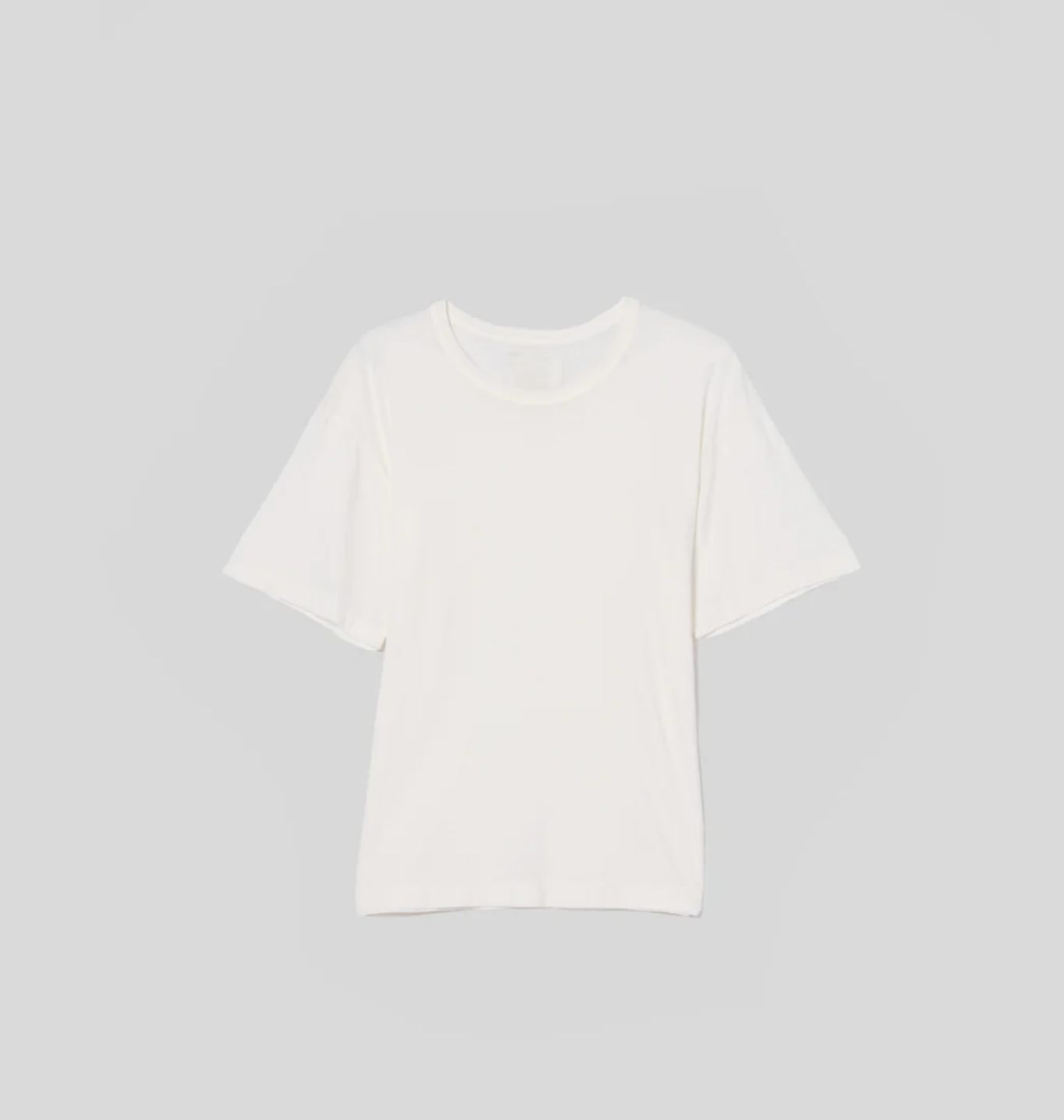 A Elisabetta Relaxed Tee In Pashmina displayed against a light gray background. The shirt has short sleeves and a round neckline, presented in a flat lay view with an Arizona style.