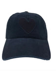 The KR Imperfect Heart Hat by Kerri Rosenthal, in black with an embroidered heart patch, is shown on a plain white background. This hat adds a subtle statement to any outfit.