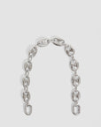 The Clare Vivier Shortie Strap/Mariner Chain features large oval and rectangular links in a gently curved, short and thick rhodium-plated design, shown on a plain white background.