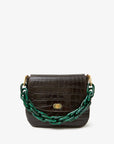 The Clare Vivier Shortie Strap S24 is a black crocodile-embossed leather handbag featuring a gold clasp and a chunky dark green resin chain strap, shown on a plain white background.