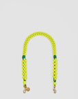 The Clare Vivier Shoulder Strap S25 is a 26.5-inch neon yellow braided Sailcord strap with two metal clasps and a small round charm, shown in a U-shape on a white background—perfect as a sporty bag accessory.