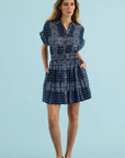 Blue patterned Howard Dress with elastic waist and pockets by Hunter Bell NYC on a light blue background.
