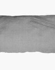 The Hedgehouse Throwbed is a rectangular gray pillow with a subtle seam and two thin fabric ties on the top right corner. It features a removable, machine-washable cotton cover and is pictured against a plain white background.
