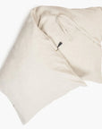 Two Hedgehouse Throwbed pillows in light beige, featuring a soft texture, overlap on a white background. One pillow displays fabric ties and includes a removable cotton cover for easy cleaning.