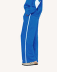 Kerri Rosenthal blue fleece palazzo pants with matching top and beige shoes, styled side view for Bungalow Furniture.