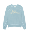 The College Sweatshirt S25 by The Great Inc. is a light blue oversized sweatshirt with white trim, featuring "Happy Hanukkah" in cream playful letters and small stars around the text.