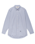 The Menswear Button Up by The Great Inc. features light blue and white vertical pinstripes, a collar, and a small embroidered monogram on the lower right front, inspired by vintage work shirts. Displayed on a plain white background.