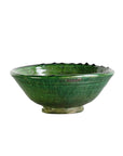 The Tamegroute Bowl by Blue Ocean Traders is a shallow, round piece with a small base and wide rim, finished in glossy green glaze. Its handcrafted ridges and texture create a striking accent against any plain white background.