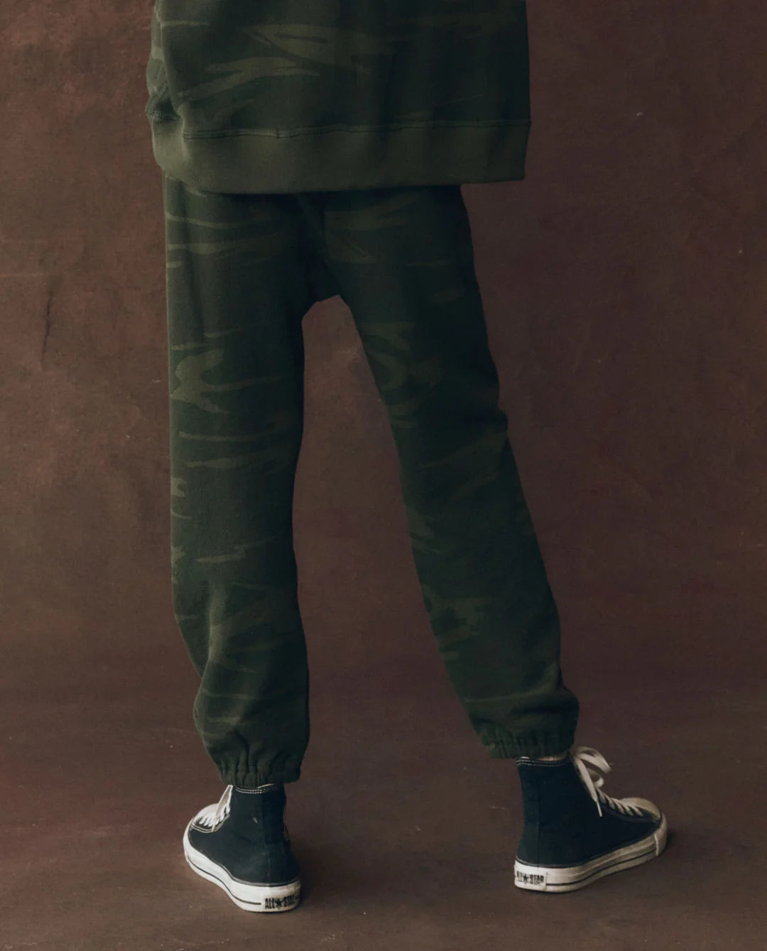 A person wearing The Stadium Sweatpant by The Great Inc., inspired by vintage athletic wear and handcrafted in Los Angeles.