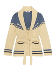 The Great Inc. presents The Western Riding Cardigan, a cream sweater with blue accents, shawl collar, geometric upper pattern, two front pockets, and tie belt at the waist. Garment shown against a white background.