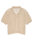 The Great Inc. The Crochet Polo—beige short-sleeve top with a pointed collar, crafted from mercerized cotton in an open-knit crochet pattern, shown flat on a white background.