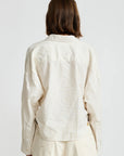 Denimist Twisted Front Shirt in white, shown from behind, worn by model with shoulder-length brown hair.