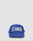 The Clare Vivier Trucker Hat Ciao features a blue design with a mesh back and "CIAO" in bold white letters, making this unisex accessory an effortless style statement. Displayed on a plain light background.