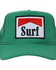 The SURF Trucker Hat by Hype Factory Inc. is a green mesh hat with an adjustable fit and a front embroidered patch featuring a red chevron above "Surf" in bold black on white.
