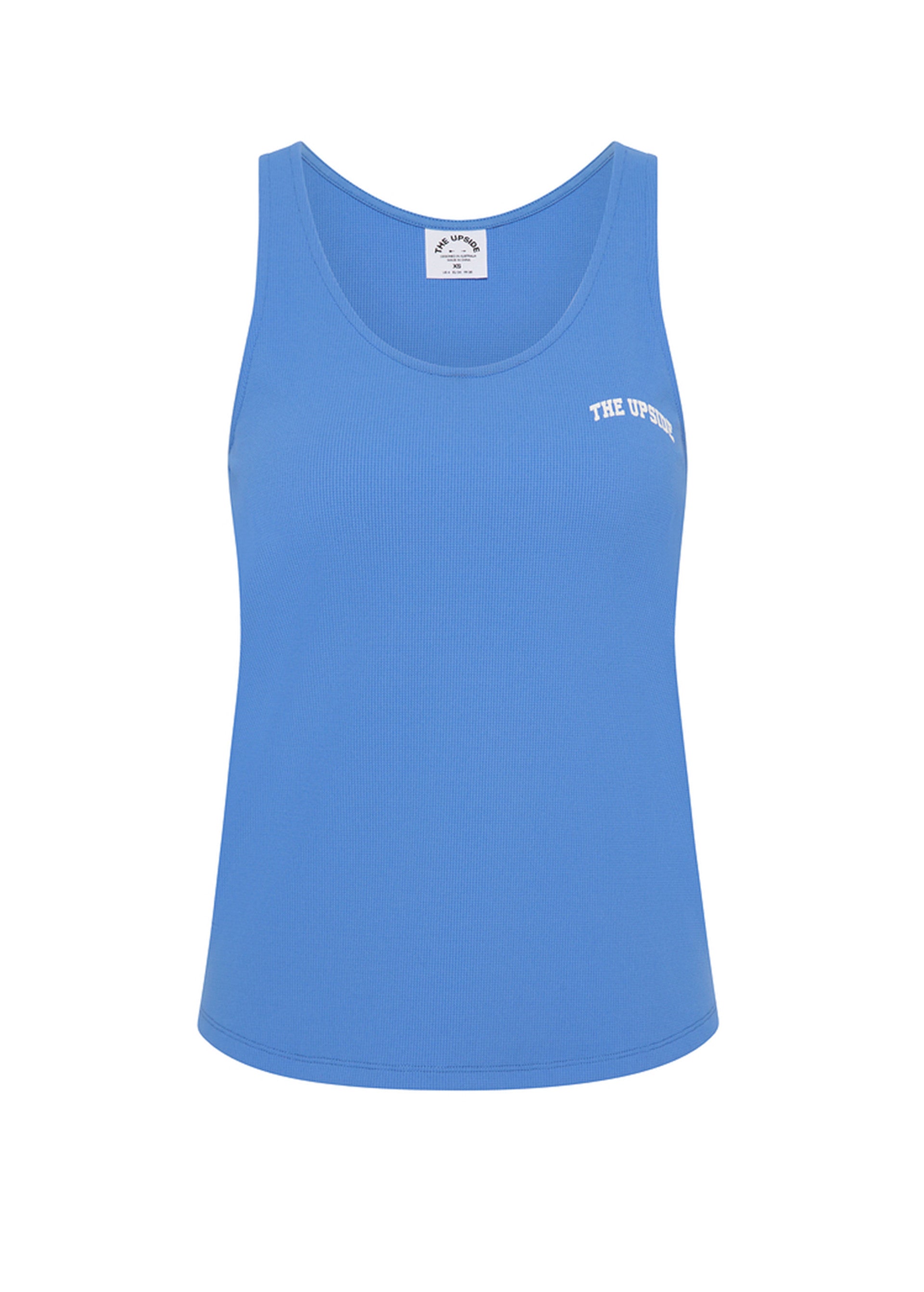 The Upside WRANGLER ISSY TANK TOP is a bright blue racerback tank with a round neckline and white logo on the left chest. Made of performance mesh, it pops against a plain white background.