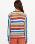 Multicolored striped long sleeve knit top by The Upside, styled with rust pants, model shown from the back.