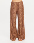 Wide-leg leopard print pants by The Upside with sandals, shown waist to feet on a white background.