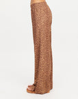 Brown leopard print JAVAN JULIET PANT by The Upside styled with sandals, side view against white backdrop.