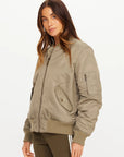 The Upside TRIBUTE BOMBER JACKET in black, front view, styled by model against white background.