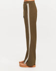 Olive The Upside PETRA FLARE PANT with white stripes, shown side view with platform sandals.