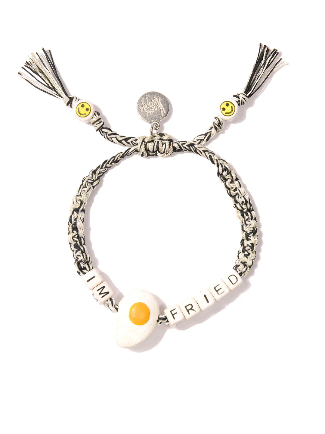 Venessa Arizaga's Bracelet 6" is a quirky black-and-white braided charm bracelet with “IM FRIED” beads, a fried egg charm, yellow smiley face beads, playful tassels, and a fun junk food-inspired vibe.
