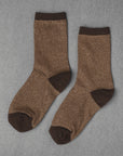 Unified Glitter Socks in brown feature darker brown toes, heels, and cuffs. Displayed flat on a gray textured surface.