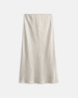 The Claire Skirt by Alex Mill is a high-waisted, off-white satin bias cut skirt with a subtle sheen and gently wrinkled texture, perfect for effortless day-to-night style. Shown against a plain white background.