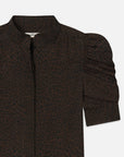 A close-up of The Leopard Gillian Top by FRAME, showcasing its silk fabric, puffed sleeves, and high neckline.